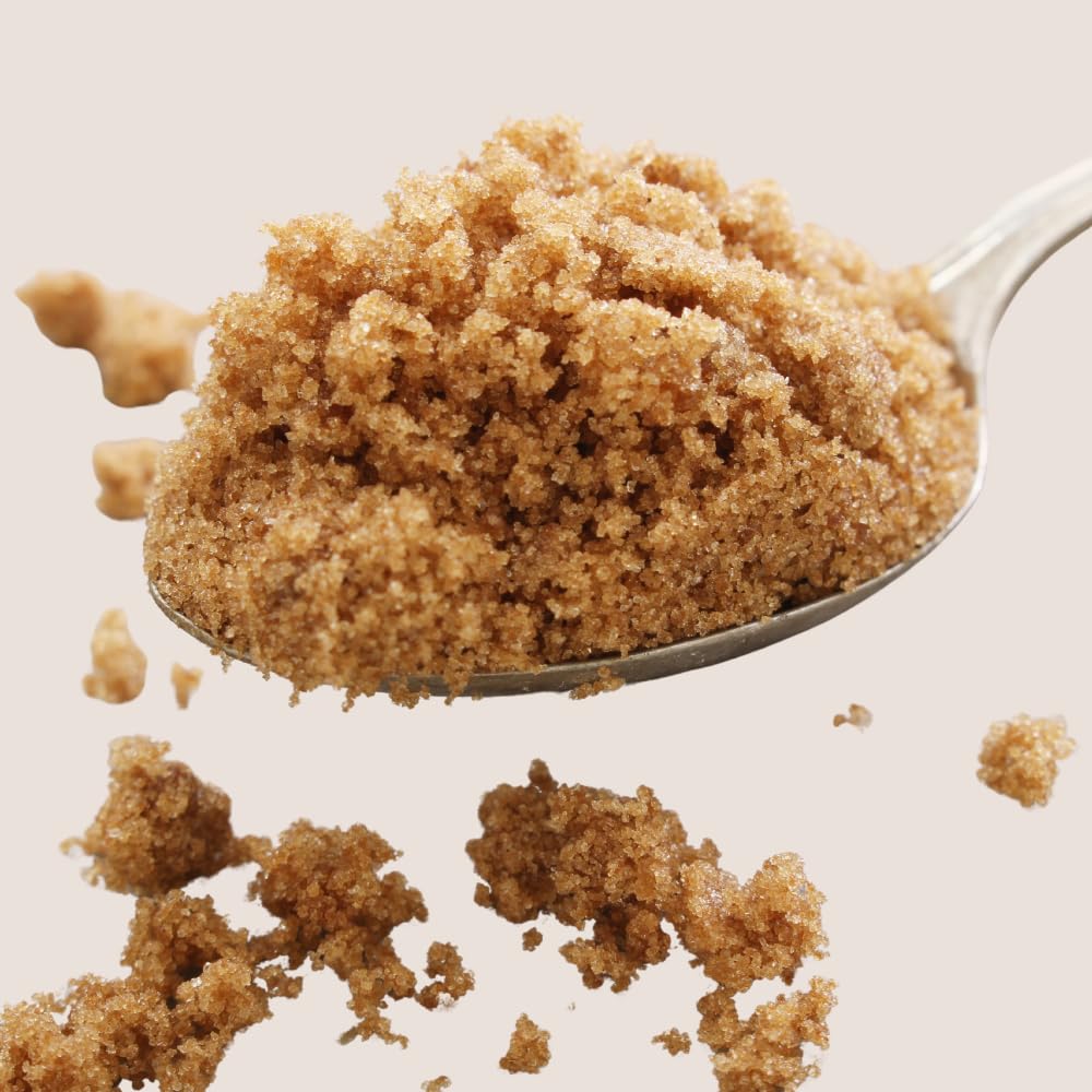 Light brown sugar on spoon showing moist texture and natural sweetness