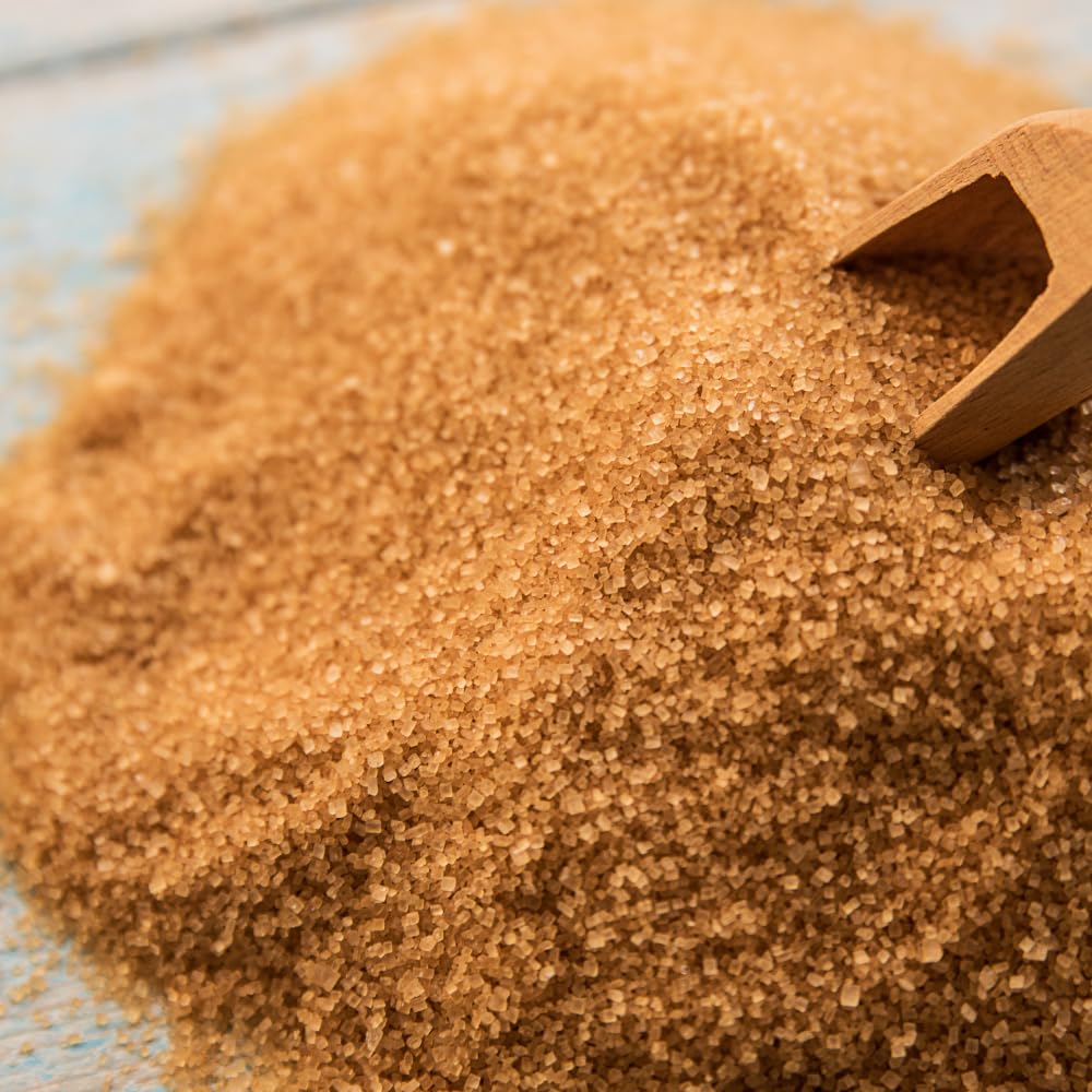 Close-up of natural light brown sugar granules texture organic sugar crystals