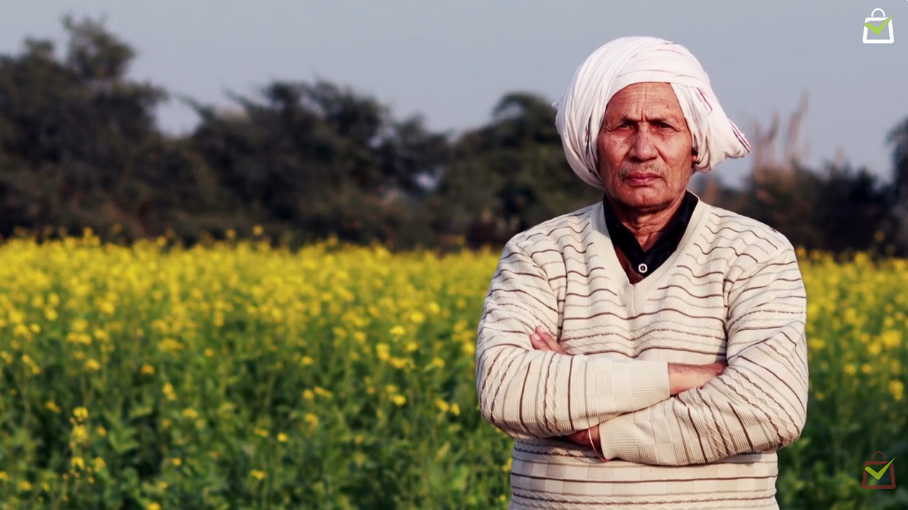 Indian farmer standing in a mustard field representing authentic food, farmer trust and purity by Milawat Free